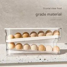 White plastic refrigerator slide-out egg dispenser tray mounted on refrigerator door