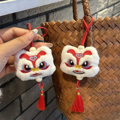 Handmade blue plush lion keychain with tassels and star stone decoration.