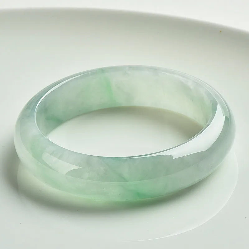 Light green jade stone bracelet showing natural mineral texture on wrist