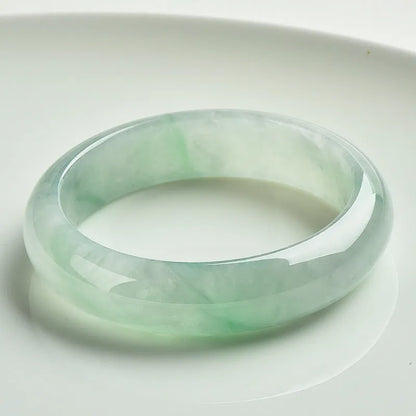 Light green jade stone bracelet showing natural mineral texture on wrist