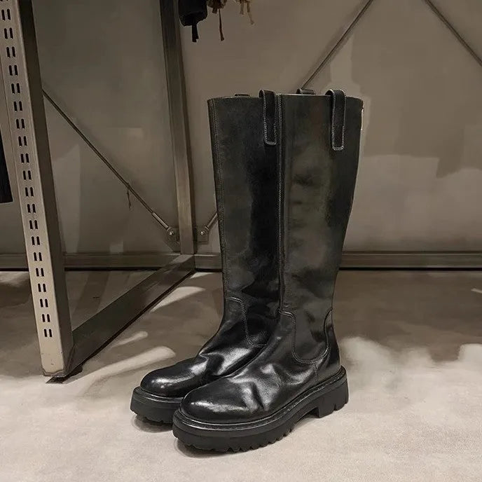 Round toe black chunky heel women's knight boots with a back zipper on a rubber sole.