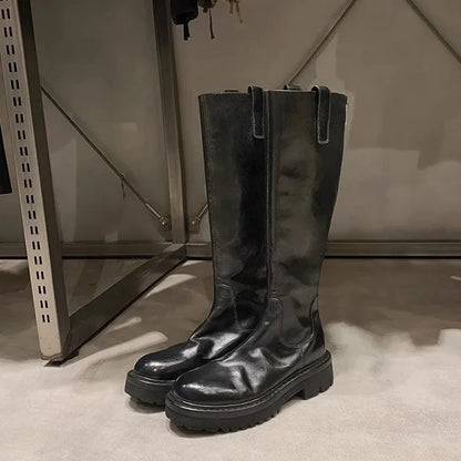 Round toe black chunky heel women's knight boots with a back zipper on a rubber sole.