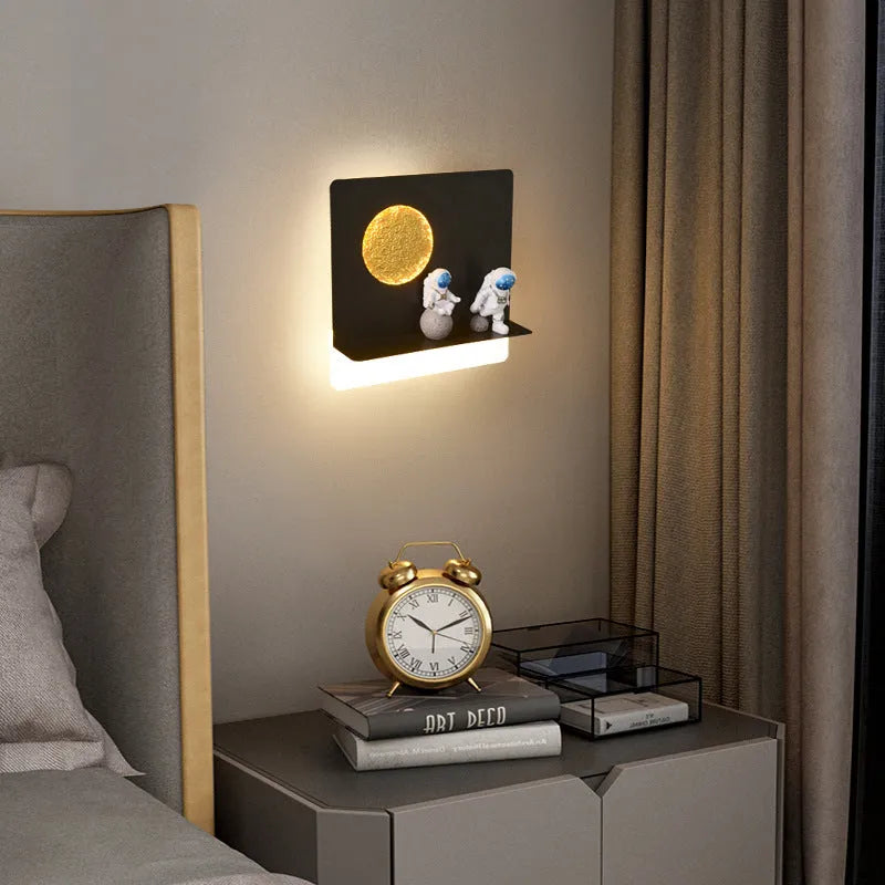 Astronaut-shaped wall lamp with small shelf in black or white finish for bedside placement