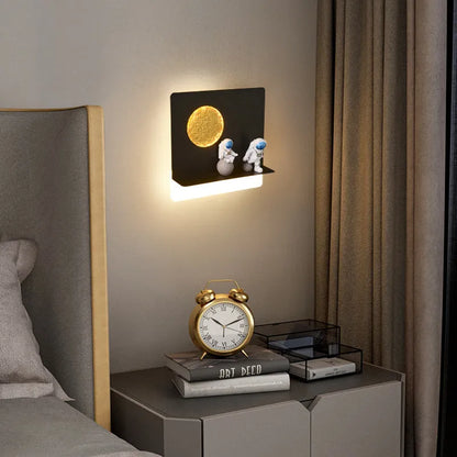 Astronaut-shaped wall lamp with small shelf in black or white finish for bedside placement