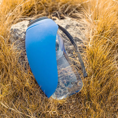 Blue portable pet water bottle with drinking bowl for dogs, showing 680ml capacity and hanging attachment