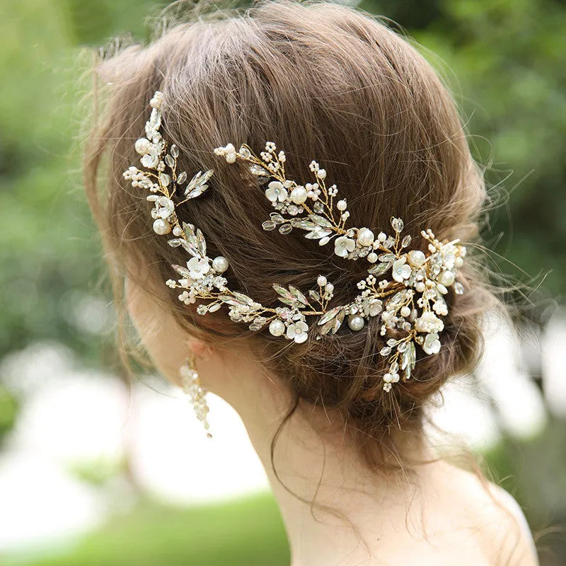 Gold bridal hair clip 27 x 13cm and earrings 6.5 x 4cm with rhinestone, crystal and imitation pearl details.