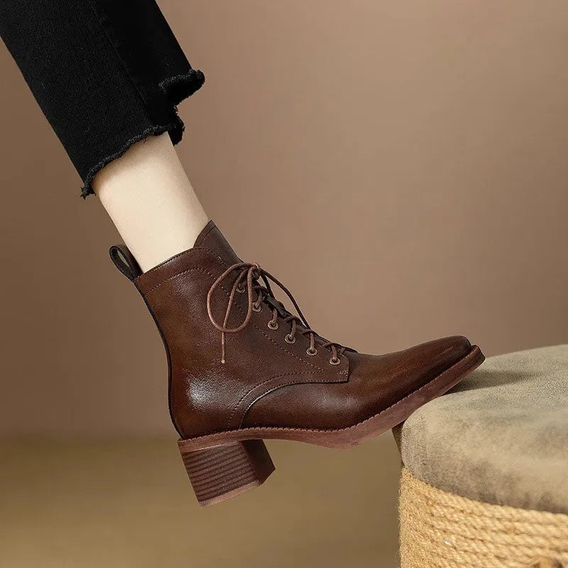 Women's black pointed toe short tube boots with a 5.5cm heel on a white background.
