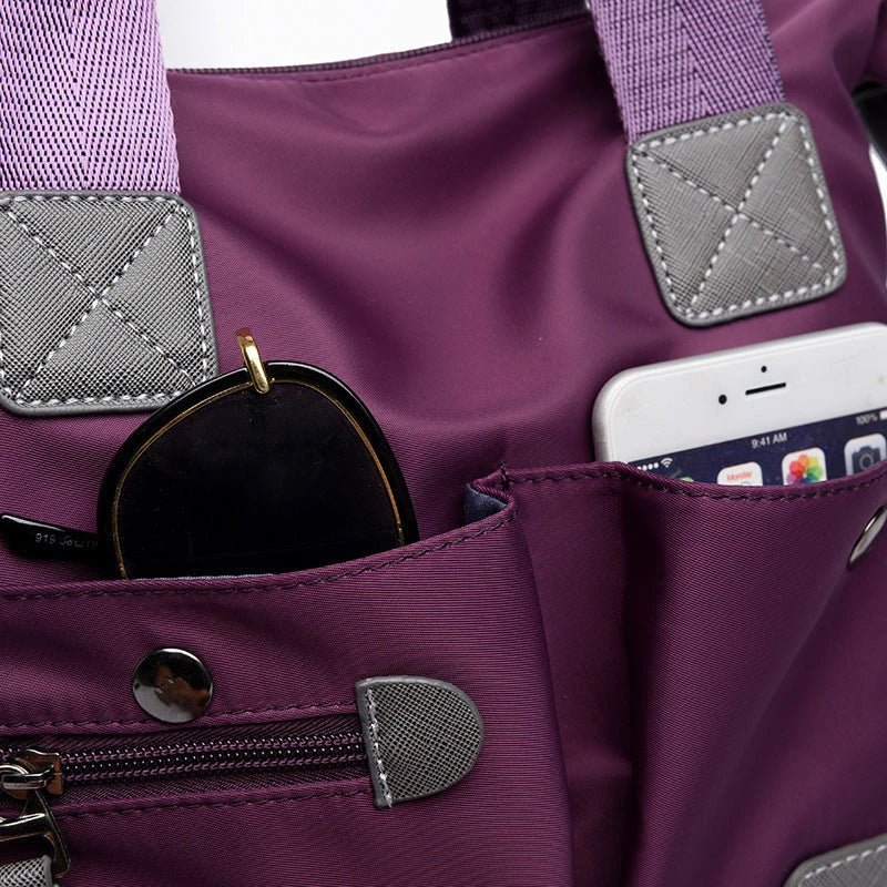 A fashionable and versatile ladies tote bag with multiple compartments and carrying options for the modern woman on the move.