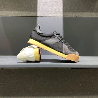 Men's black cow suede and mesh summer sports shoe with mid-heel and herringbone toe pattern on a white background.