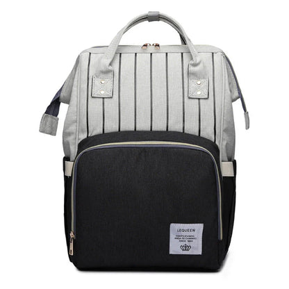Stylish maternity diaper bag in various colors, featuring a paper bag design, separate bottle compartment, and discreet breastfeeding button.