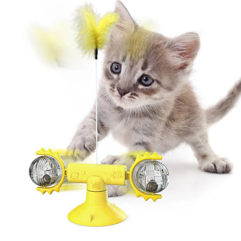 Cat playing with rotating windmill toy featuring luminous balls and suction base