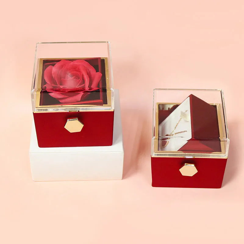 Rotating rose jewellery gift box with a preserved red rose under a clear acrylic dome, showing the interior rotating drawer.