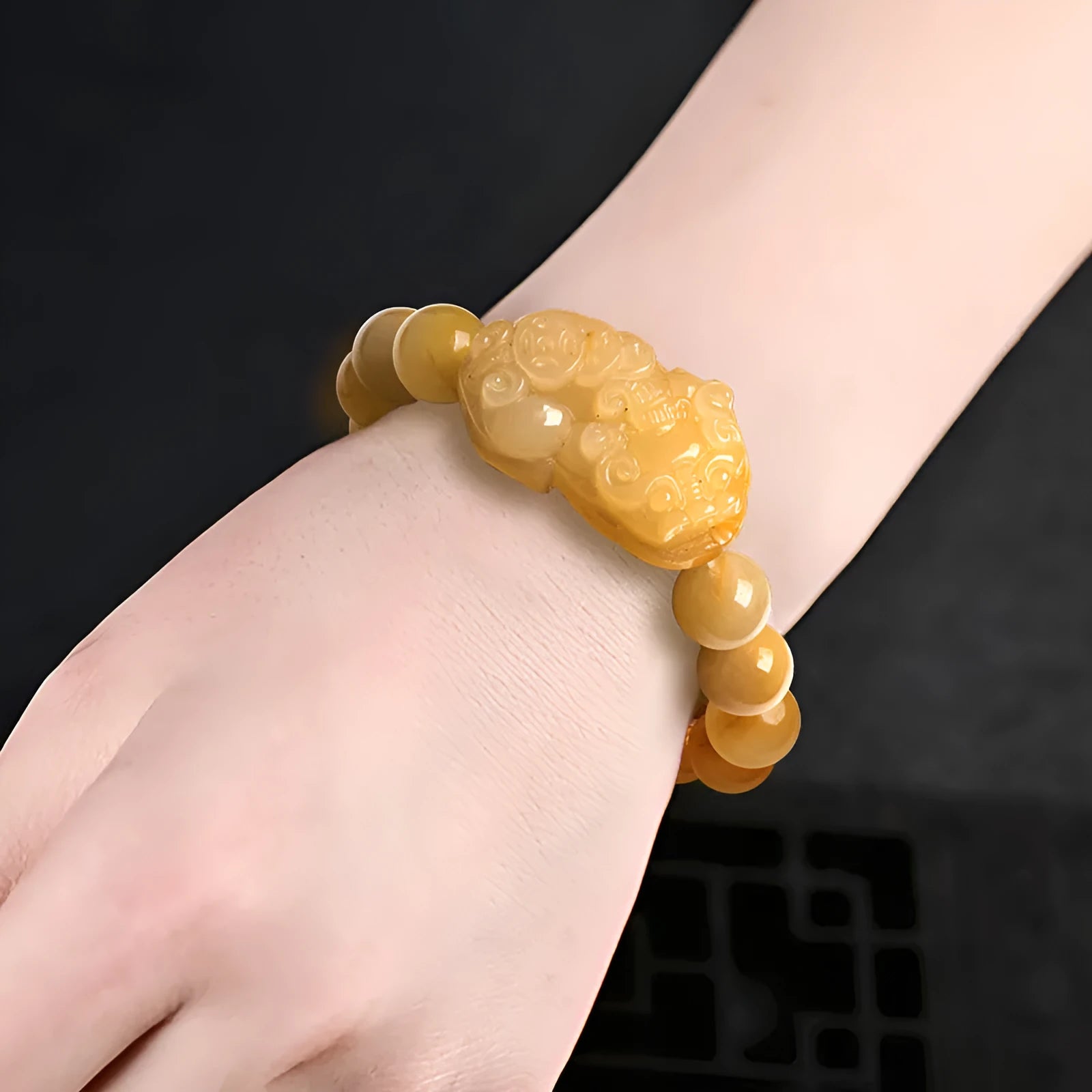 Carved jinsi jade money bracelet in golden thread colour with jade bead detailing