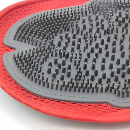 Red pet bathing glove with integrated brush bristles, measuring 26cm by 16cm, shown fitting on a hand