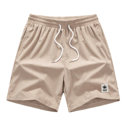 Men's straight-cut drawstring shorts in blue, shown on a model for summer casual wear.