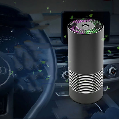 Compact black car air purifier with aluminium alloy and ABS construction, shown next to a car USB port.