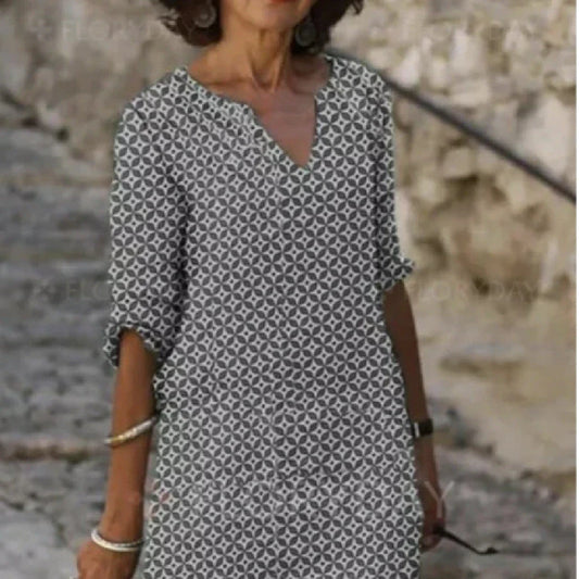 Vibrant mid-length dress with a colorful pattern, featuring a range of sizes and color options.