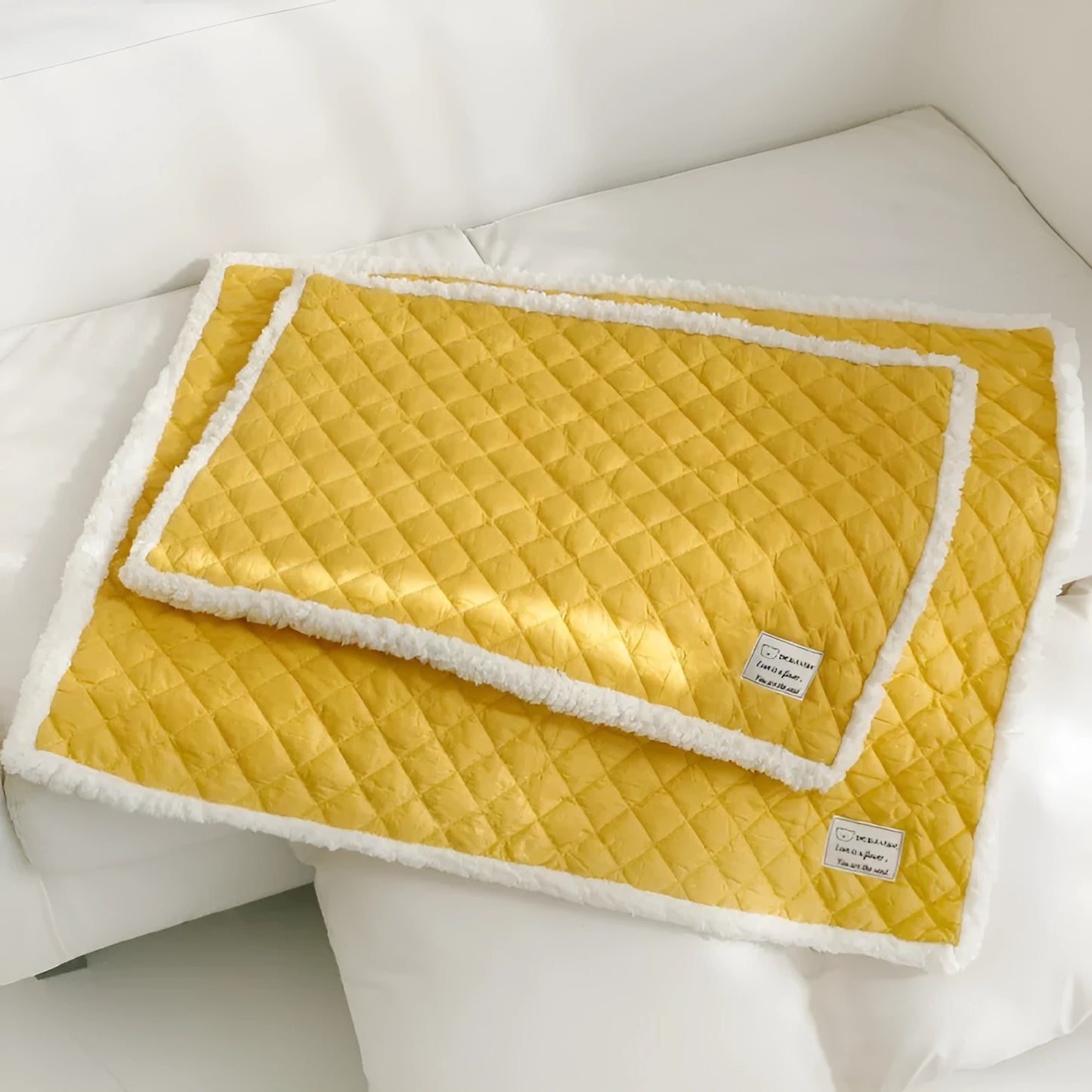Blue quilted terry cloth pet blanket for cats shown in a cage, with size options M, L, and XL available.