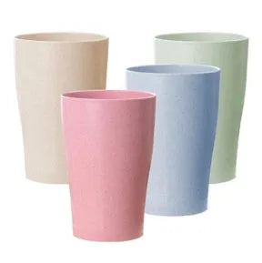 A cylindrical wheat straw plastic bathroom cup in a Nordic colour, holding toothbrushes.