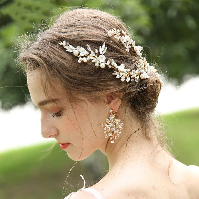 Gold bridal hair clip 27 x 13cm and earrings 6.5 x 4cm with rhinestone, crystal and imitation pearl details.