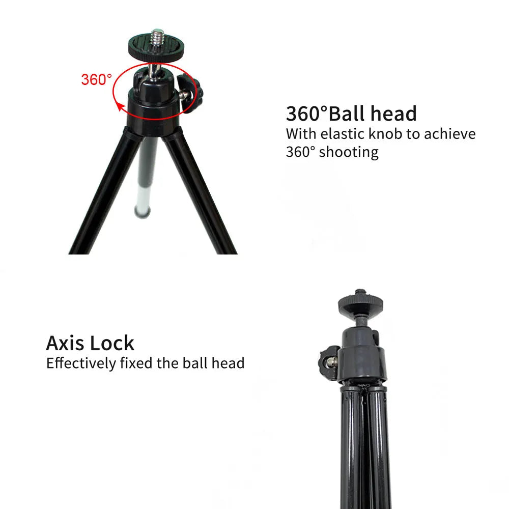Black mini camera tripod with extended legs and a separate U-shaped universal phone clip on a table.