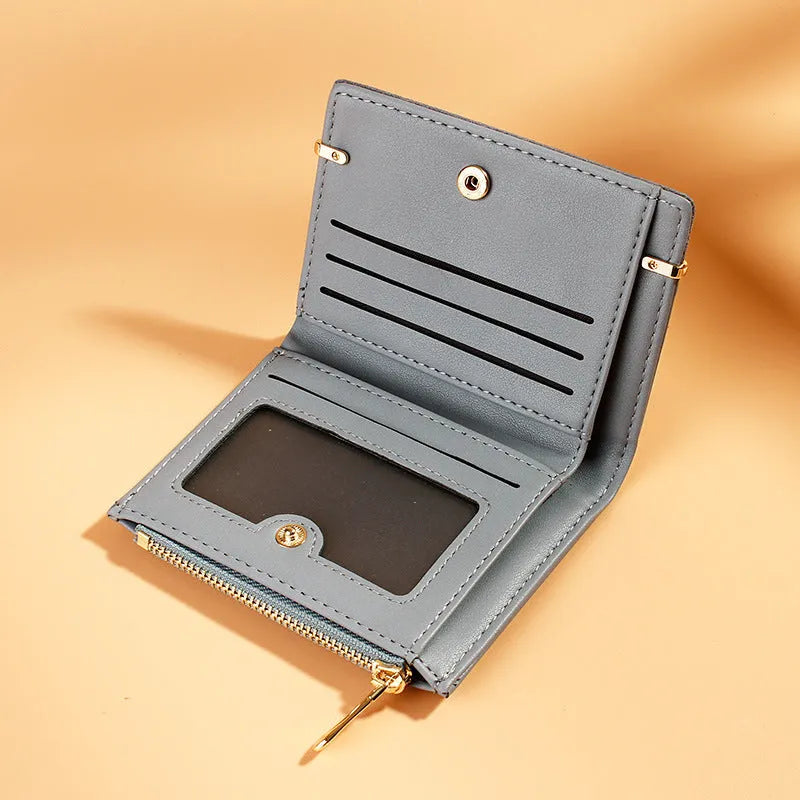 Multi card slot short zipper ladies wallet in 2-fold design with PU leather exterior showing internal compartments