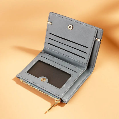Multi card slot short zipper ladies wallet in 2-fold design with PU leather exterior showing internal compartments
