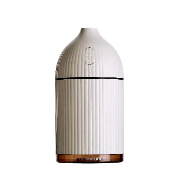 White ultrasonic aromatherapy diffuser and air humidifier with LED light, 300ml capacity, on a desk.
