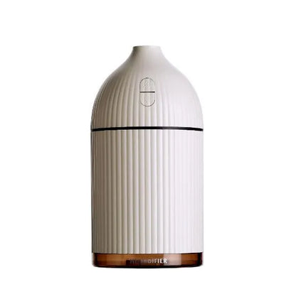 White ultrasonic aromatherapy diffuser and air humidifier with LED light, 300ml capacity, on a desk.