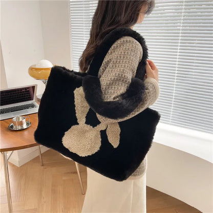 Soft plush tote bag with cartoon rabbit ears in solid colours like beige, pink, and black.
