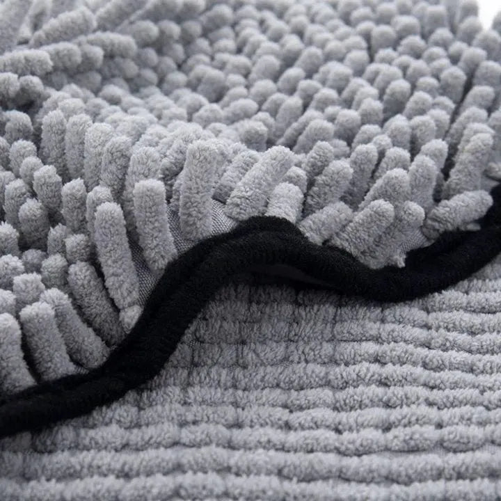Blue dog bath robe towel laid flat, showing its 62cm by 23cm size and soft texture.