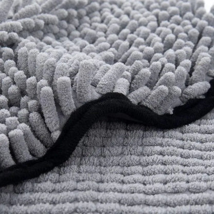 Blue dog bath robe towel laid flat, showing its 62cm by 23cm size and soft texture.