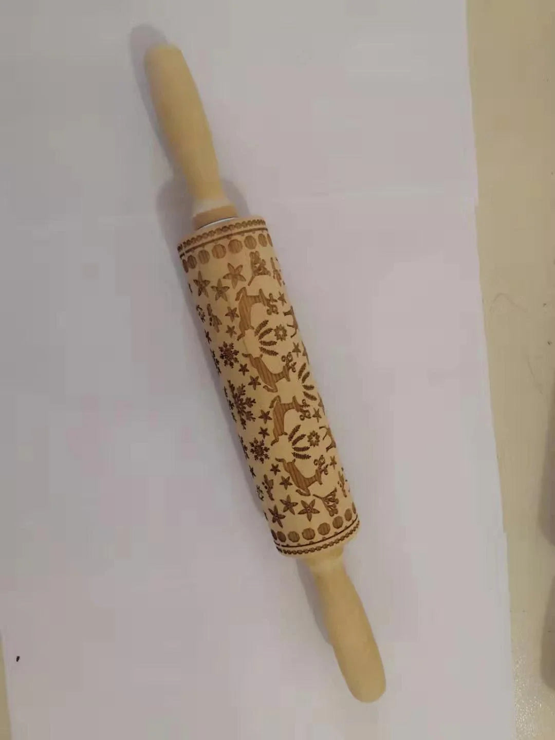 Festive rolling pin with embossed Christmas designs for easy imprinting on dough
