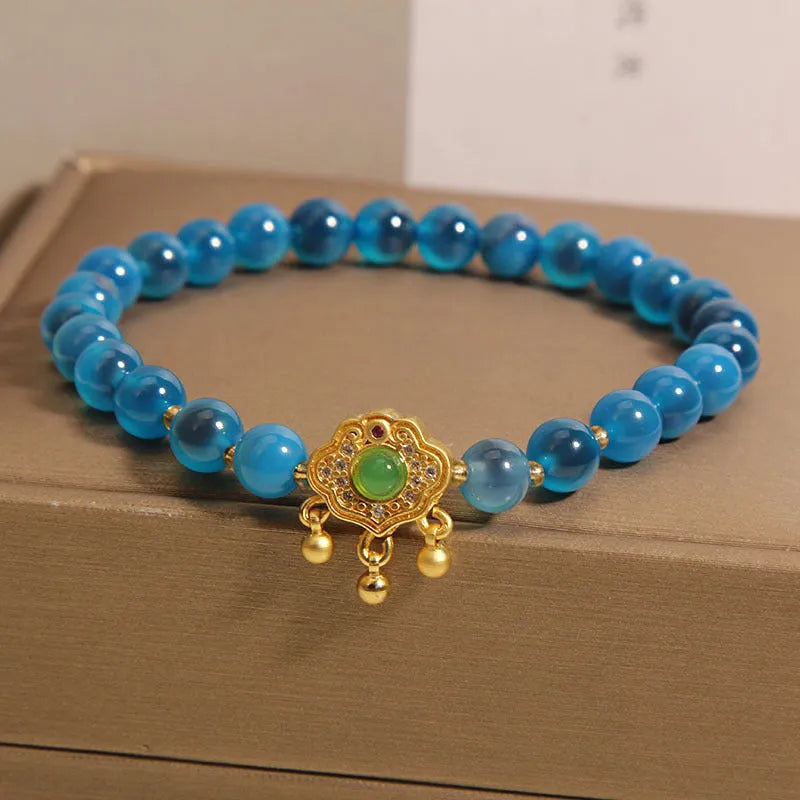 Blue sugar heart agate safety lock pendant on a women's crystal bracelet with alloy inlay and rhinestones.