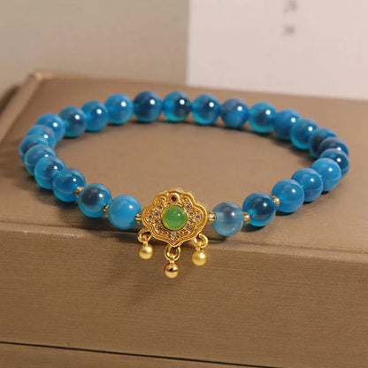 Blue sugar heart agate safety lock pendant on a women's crystal bracelet with alloy inlay and rhinestones.