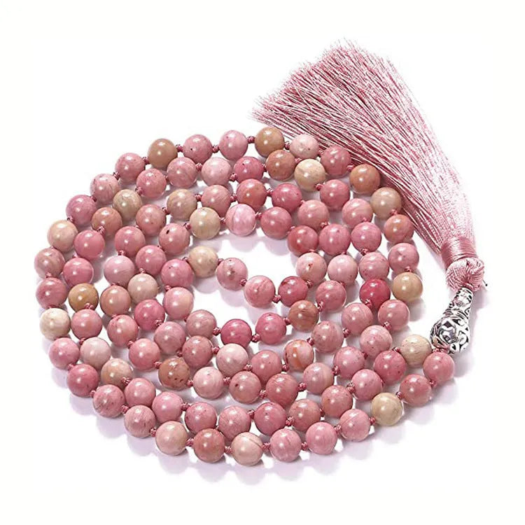 Long multi-coloured agate and stone tassel necklace with geometric beads on a white background.