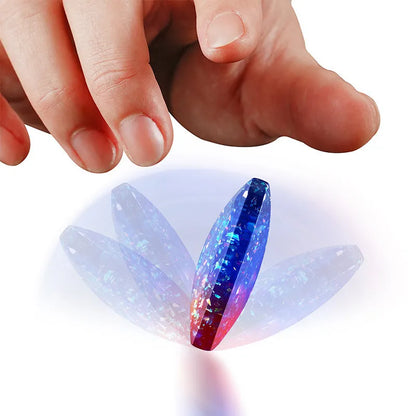 Galactic edition pocket gyro desk toy on a surface, showing its quadrilateral resin construction and celestial colour design.