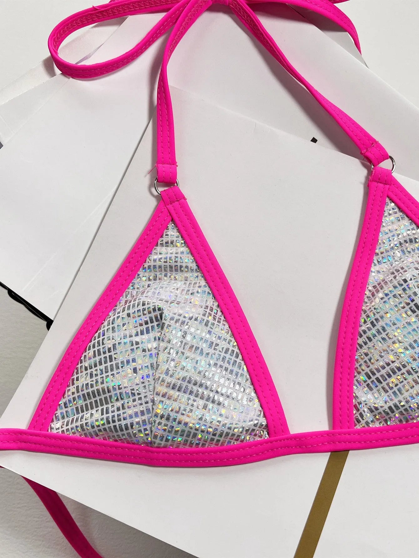 Silver solid colour women's triangle one-piece swimsuit with a split back on a mannequin.