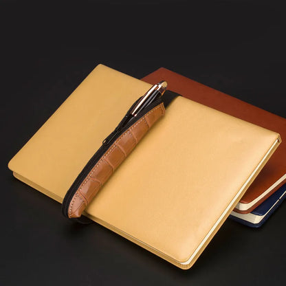 Long beige grey PU leather pencil case on a desk with pens