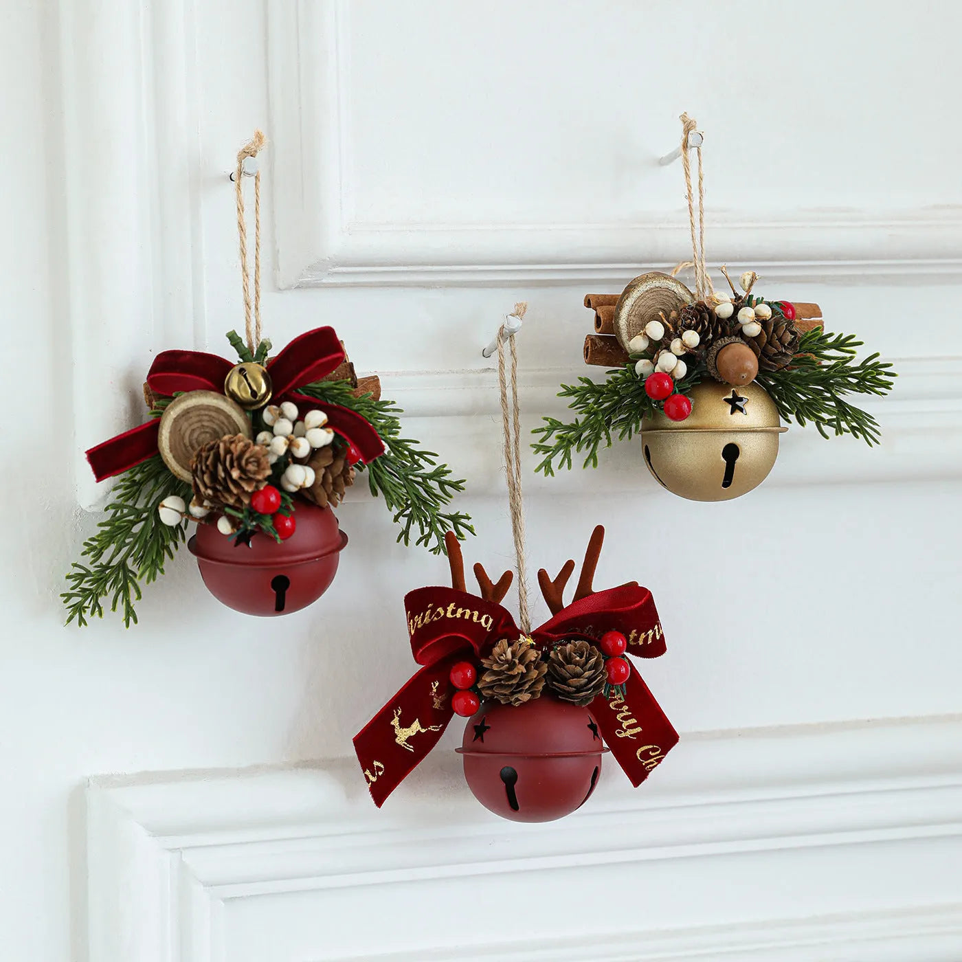 Wrought iron decorative pendant with antlers, pine cone, bowknot, and a small bell in a choice of colours.