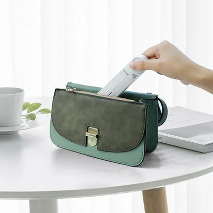 Black foldable tablet holder open in landscape mode holding a tablet, showing side buttons and non-slip base.