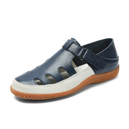 Plus size women's flat sandals with toe cap, hollow design, and thick rubber sole in blue.