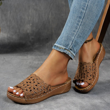 Women's wedge beach slippers with flower cutout design on PVC upper, shown in light brown colour.