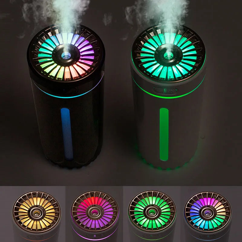 Black portable humidifier with LED lights beside car cup holder showing mist output