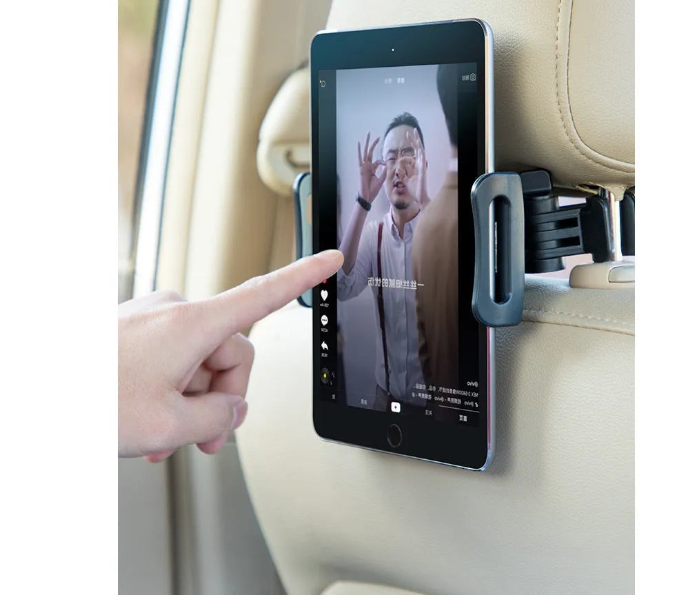 Black car phone holder mounted on vehicle rear seat with tablet secured in snap-in bracket
