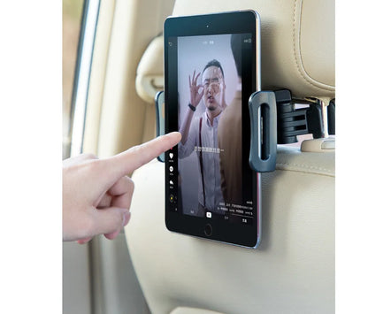 Black car phone holder mounted on vehicle rear seat with tablet secured in snap-in bracket
