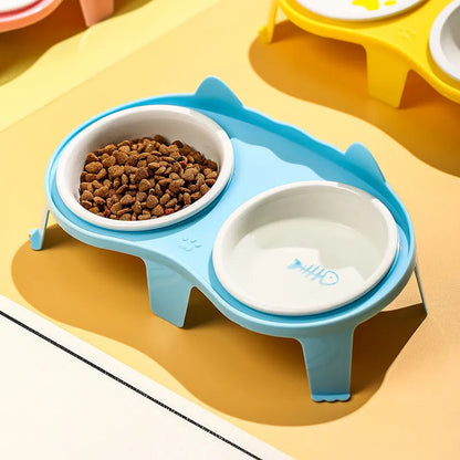 Ceramic cat food and water bowl set in elevated tilted stand, shown in blue, pink, white, and yellow colour options.