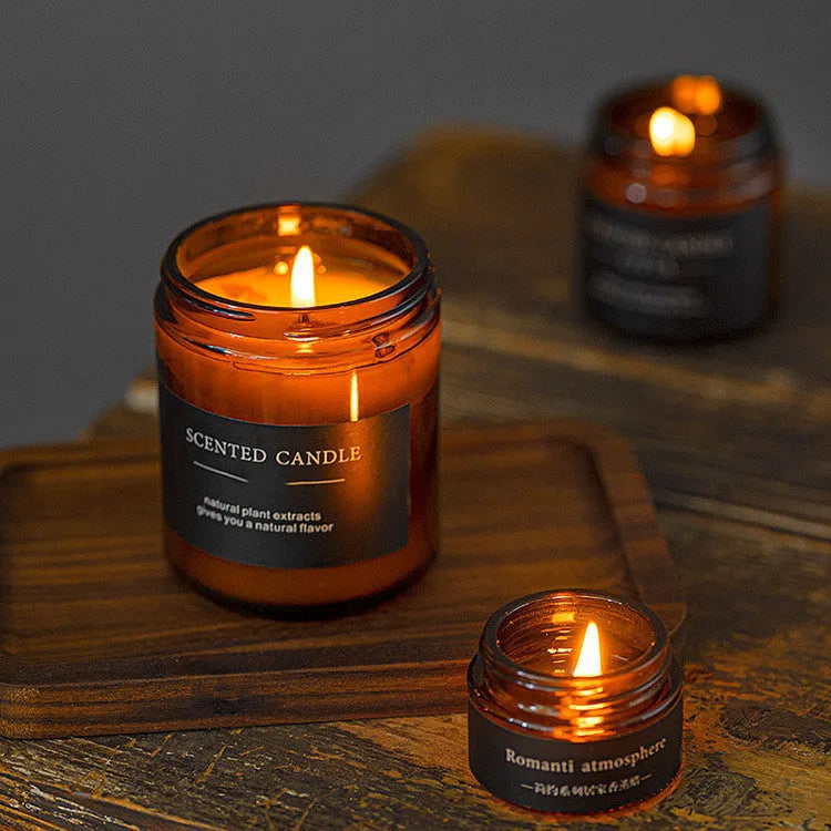Scented candle made from a soy and plant wax blend, hand-poured in a cylindrical brown glass bottle, available in three natural fragrance options including sunny rose, lavender thyme, and bayberry for home fragrance use.