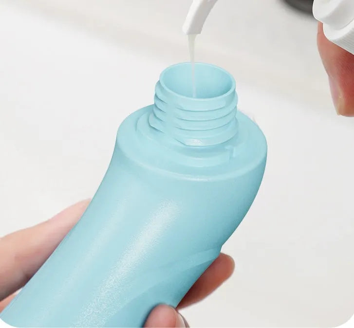 Blue hand-held pet bath brush with soft bristles for dog and cat grooming.