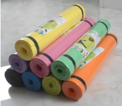 EVA composite fitness and yoga mat in blue, showing its texture and rolled edge next to a storage bag.